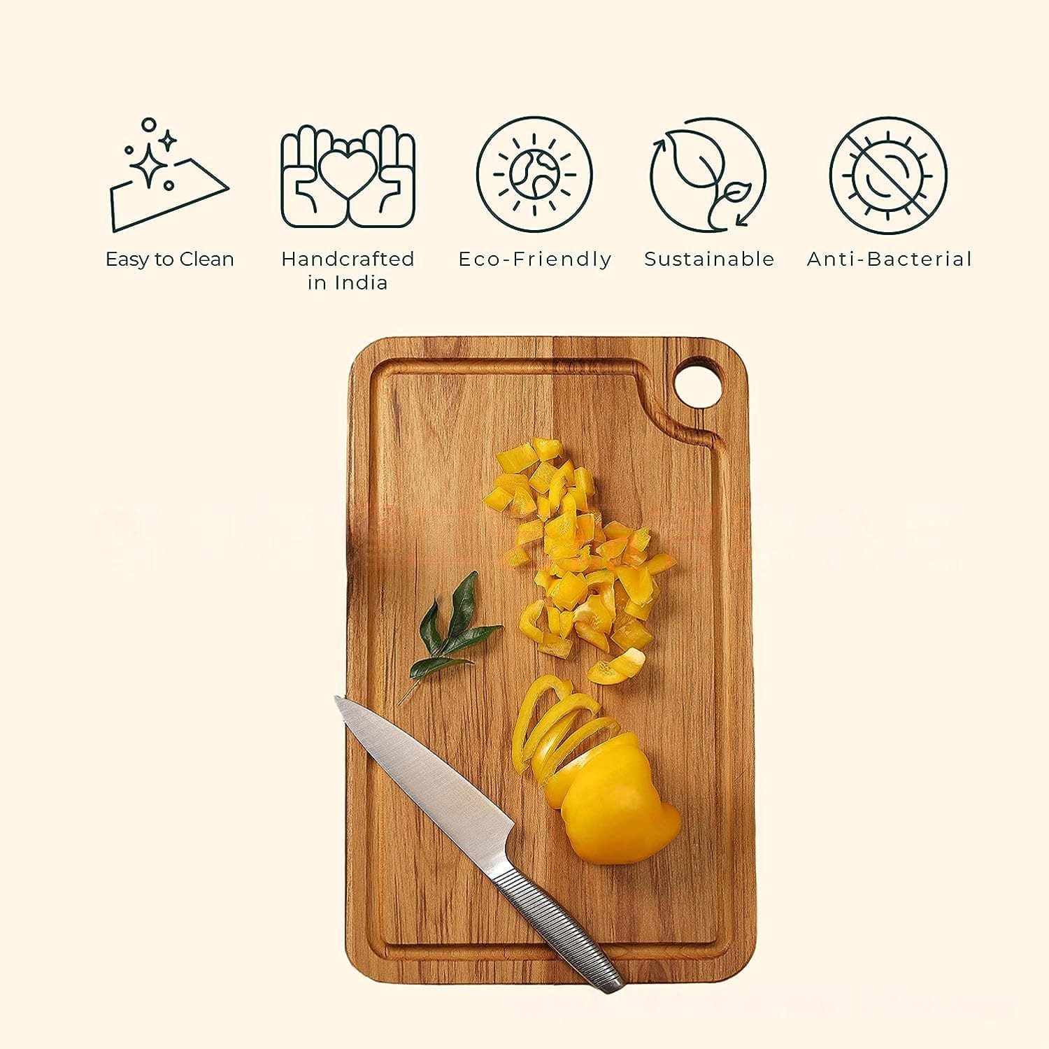 Double-sided wooden cutting board with yellow bell peppers and knife. Eco-friendly and anti-bacterial.
