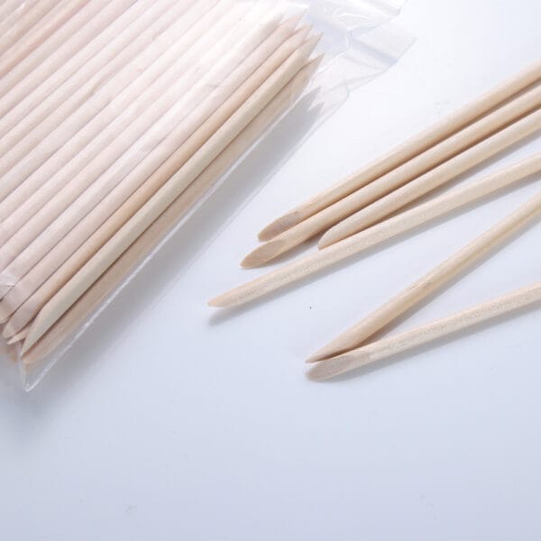 Orange wood stick for manicure and nail care; a bulk bag of wooden cuticle pushers