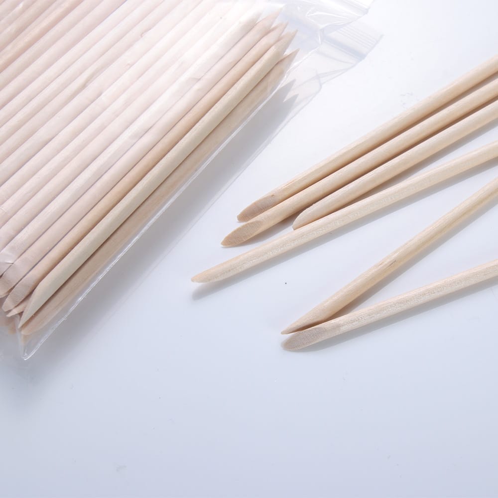 Orange wood stick for manicure and nail care; a bulk bag of wooden cuticle pushers