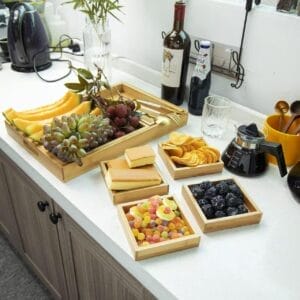 Bamboo trays filled with fruit, snacks, and sweets. Eco-friendly wooden trays perfect for wholesale.