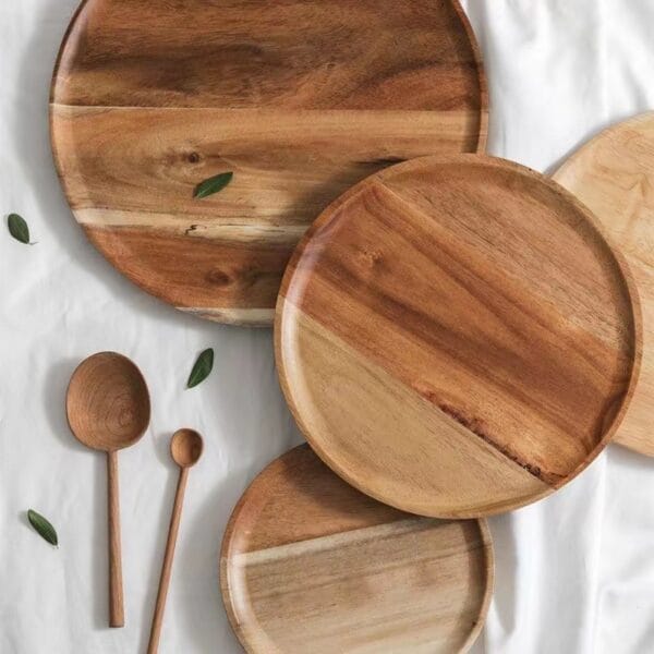 Three round acacia wood trays of varying sizes, perfect for wholesale or retail.