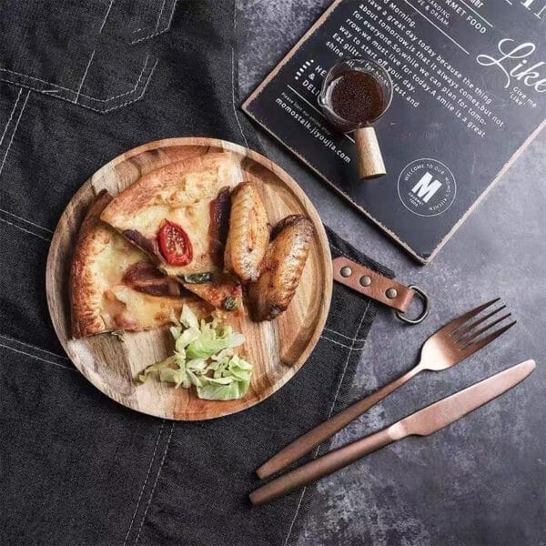Round acacia wood tray with pizza, chicken wings, and salad. Wholesale wooden trays available.