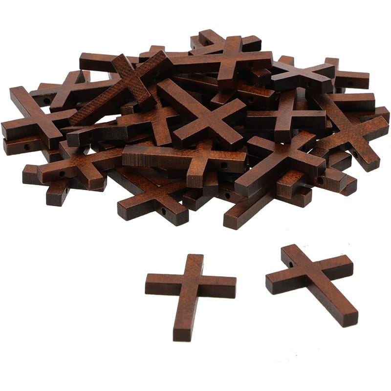 Pile of small wooden crosses; ideal for Easter crafts, home decor, or jewelry making. Eco-friendly.