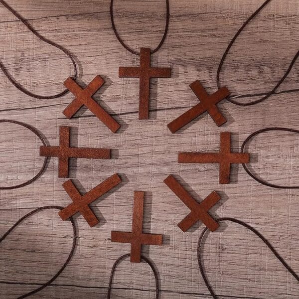 Assortment of small, brown wooden cross necklaces. Eco-friendly Easter and home decor.