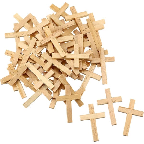 Pile of small, unfinished wooden crosses. Eco-friendly Easter and home decor craft supply.
