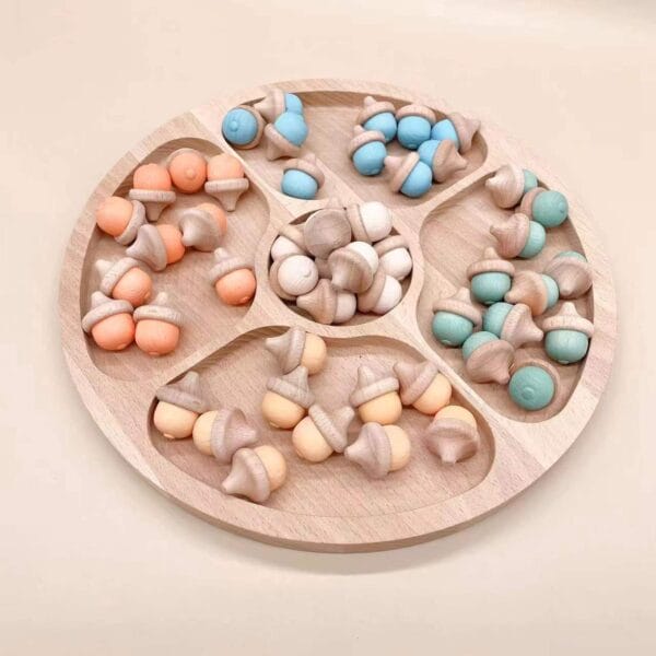 Wooden tray with colorful acorn-shaped counters.