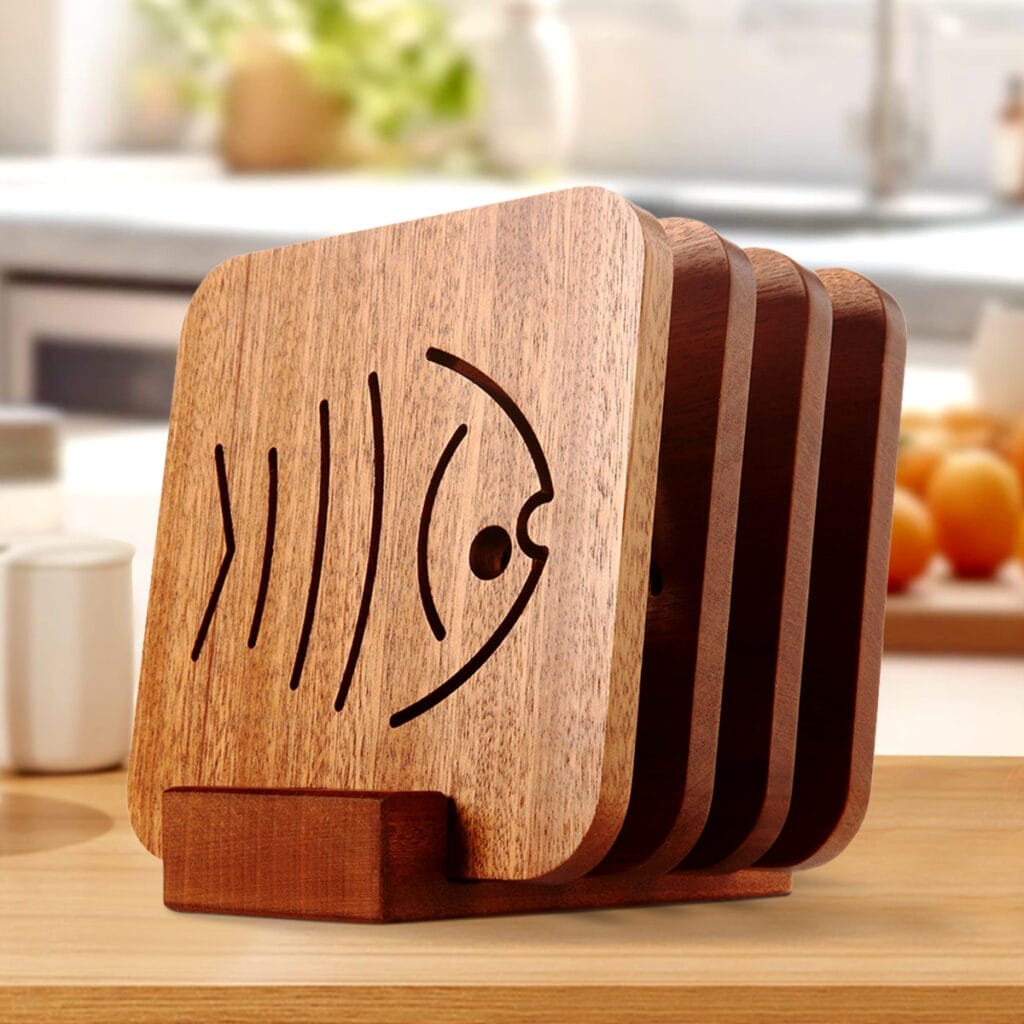 Set of square wooden coasters with a cut-out fish design, displayed in a wooden holder. Perfect for tea or drinks.