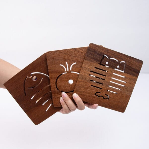 Set of three square solid wood coasters featuring cute animal cutouts; perfect for tea, coffee, or drinks.