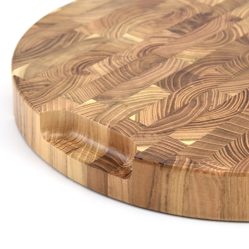 Round teak end-grain cutting board with finger hole. Wholesale wood chopping board.