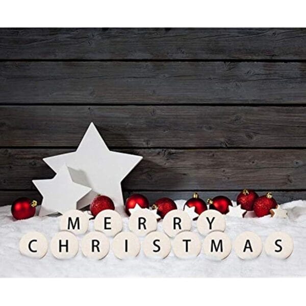 Merry Christmas message spelled with white wood cutout letters, surrounded by red ornaments and white stars on a rustic wood background.