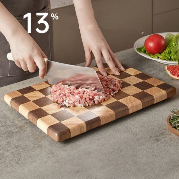 Chef using a large walnut cutting board to chop meat. Wholesale kitchen boards.