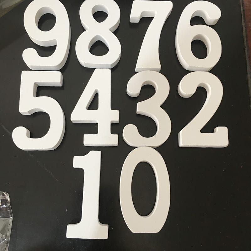 White wooden letters 1, 0, 2, 3, 4, 5, 6, 7, 8, 9. Modern minimalist home decor.