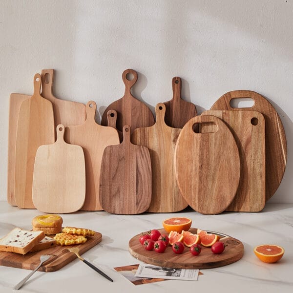 Assortment of acacia wood cutting boards, various shapes and sizes. Wholesale supplier of acacia wood cutting boards for distributors.