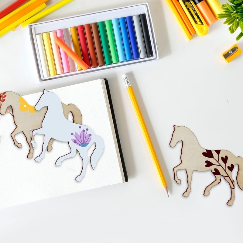 Wooden horse craft cutouts with colorful pastels and pencils. Wholesale wooden pieces for home decor.