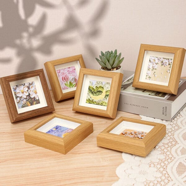 Six mini square wooden picture frames displaying various artwork. Wholesale wood picture frames.