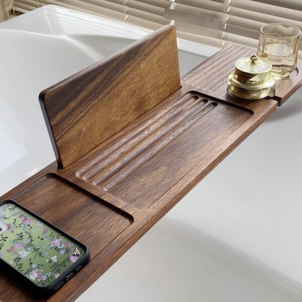 Luxury wooden bathtub caddy with phone holder, glasses, and container. Wholesale wood bath tray manufacturer.