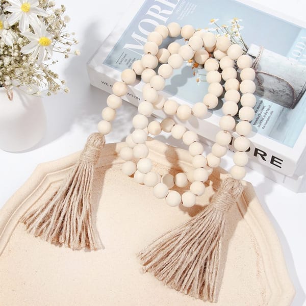 Natural wood bead garland with jute tassels. Wholesale wood bead garland supplier.