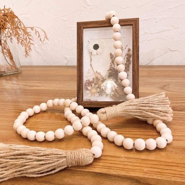 Natural wood bead garland with jute tassels, handcrafted by a wood bead garland manufacturer. Wholesale supplier of natural wood beads.