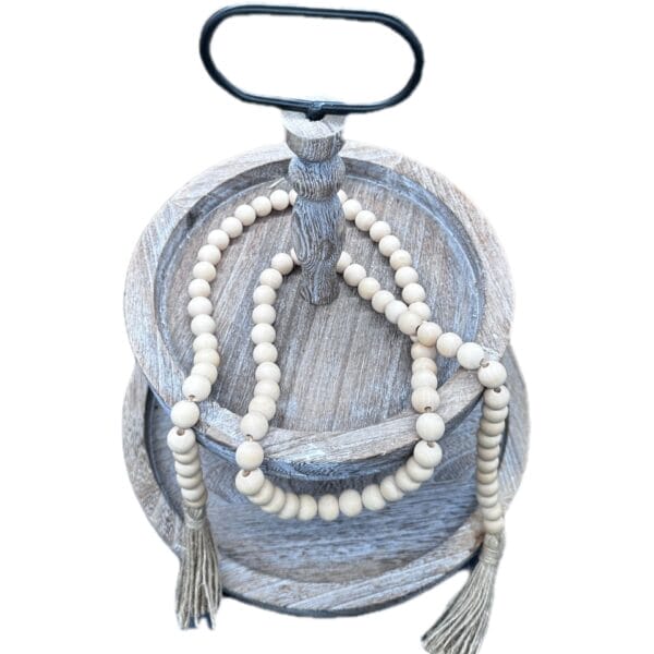Two-tiered wooden tray with natural wood bead garland. Wholesale supplier of wood beads.