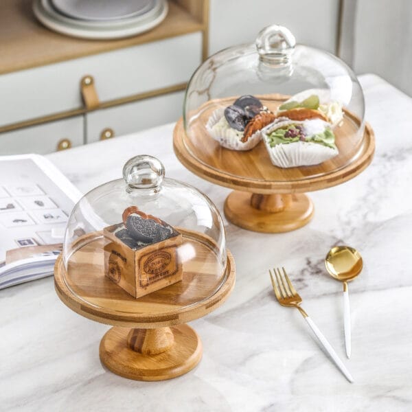 Bamboo cake stands with glass domes; perfect for displaying pastries. Wholesale options available. High foot design.