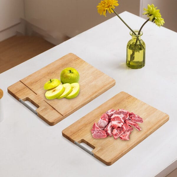 Two eco-friendly bamboo cutting boards, one with sliced apples, the other with raw pork ribs. Wholesale cutting boards available.