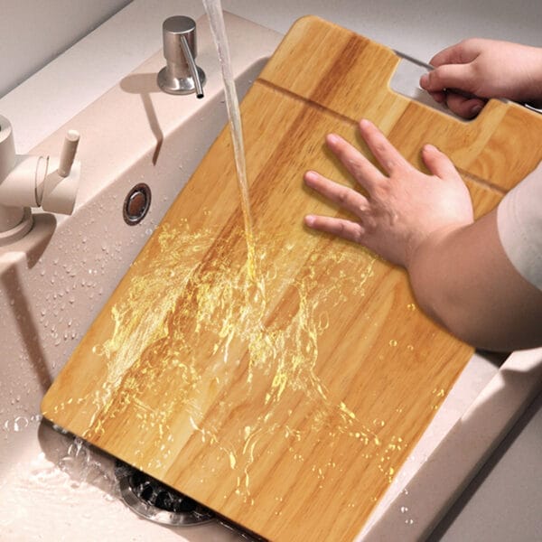 Eco-friendly bamboo cutting board being rinsed under water. Wholesale cutting boards available.