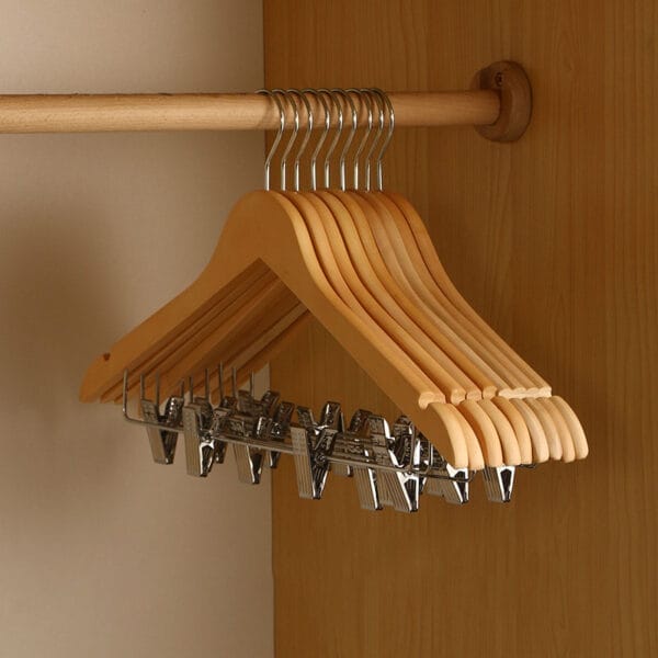 Wooden clothes hangers with clips, wholesale pricing. Ideal for home closet organization. Non-slip design.