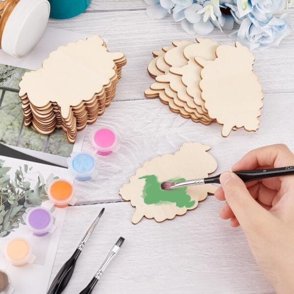 Wooden sheep craft shapes with paint and brushes. Wholesale wood craft shapes available.