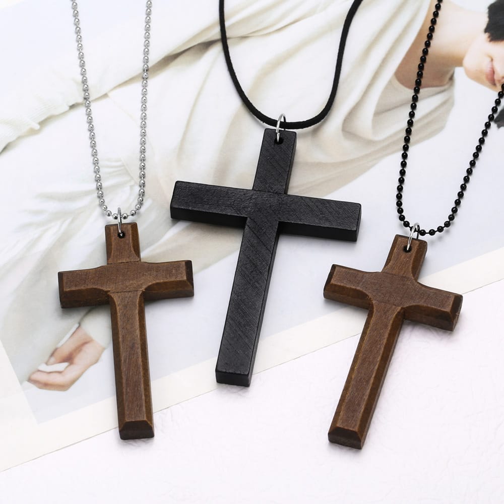 Wood cross necklace: Set of three stylish cross pendants—dark brown, black, and light brown wood—with varying chain styles. Religious jewelry.