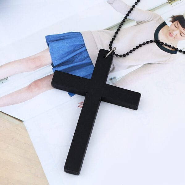 Black wooden cross necklace with a black beaded chain. Stylish and simple.