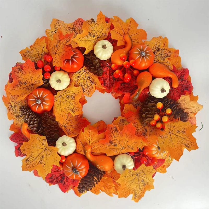 Autumnal wreath with pumpkins, gourds, and maple leaves. Perfect fall decor.