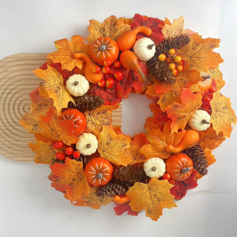 Autumnal pumpkin wreath with fall leaves, gourds, and pinecones. Perfect for Thanksgiving decor.