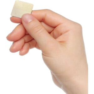 Hand holding small square wood cutout, perfect for crafting projects.