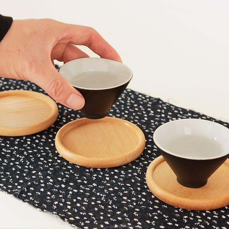 Wooden coasters with small black and white teacups. Wholesale drink coasters.
