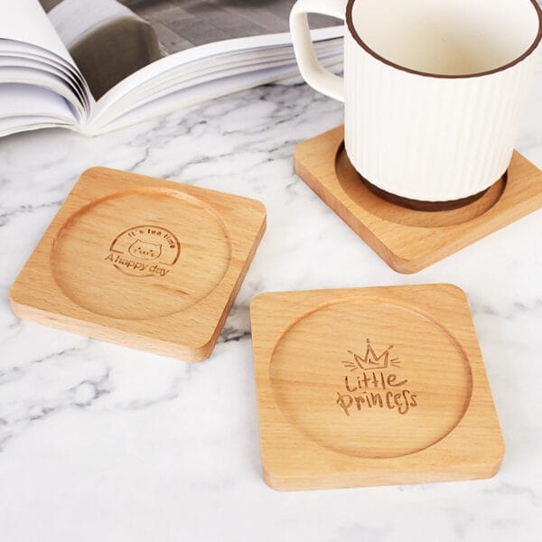 Three custom engraved wood coasters. One says "It's tea time, A happy day". Another says "Little Princess". Wholesale and distribution available.