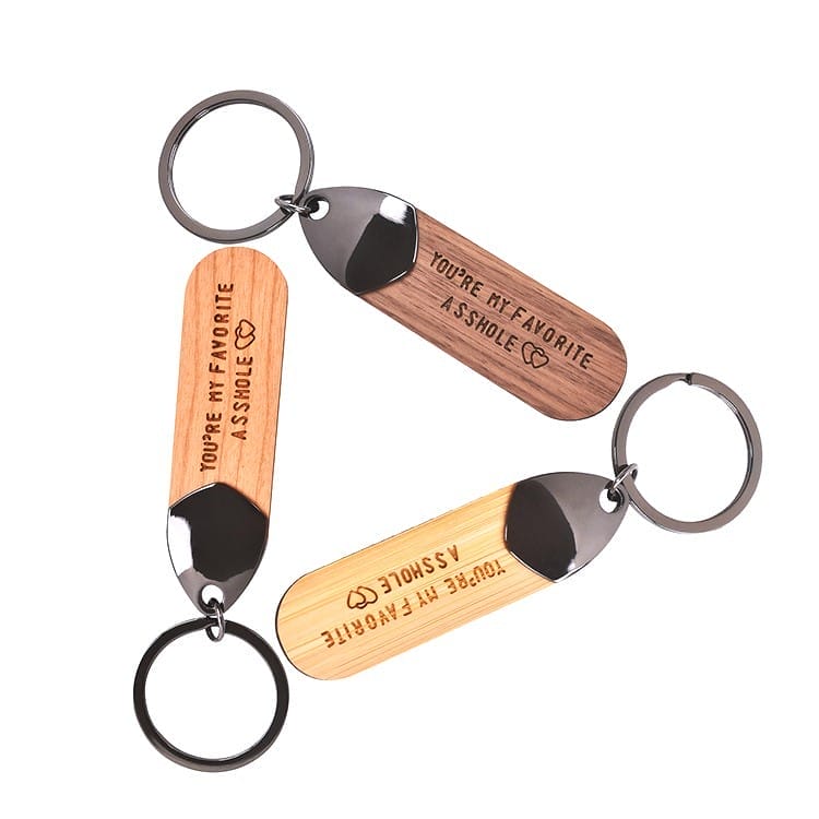 Two engraved wooden keychains, "You're my favorite asshole," wholesale supplier