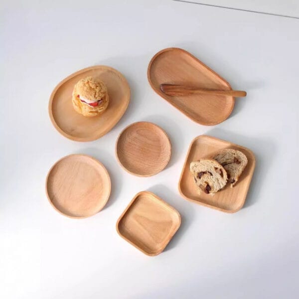 Wooden serving platters wholesale: Set of oval, square & round wooden serving trays, ideal for cakes, bread & snacks. Wholesale available.