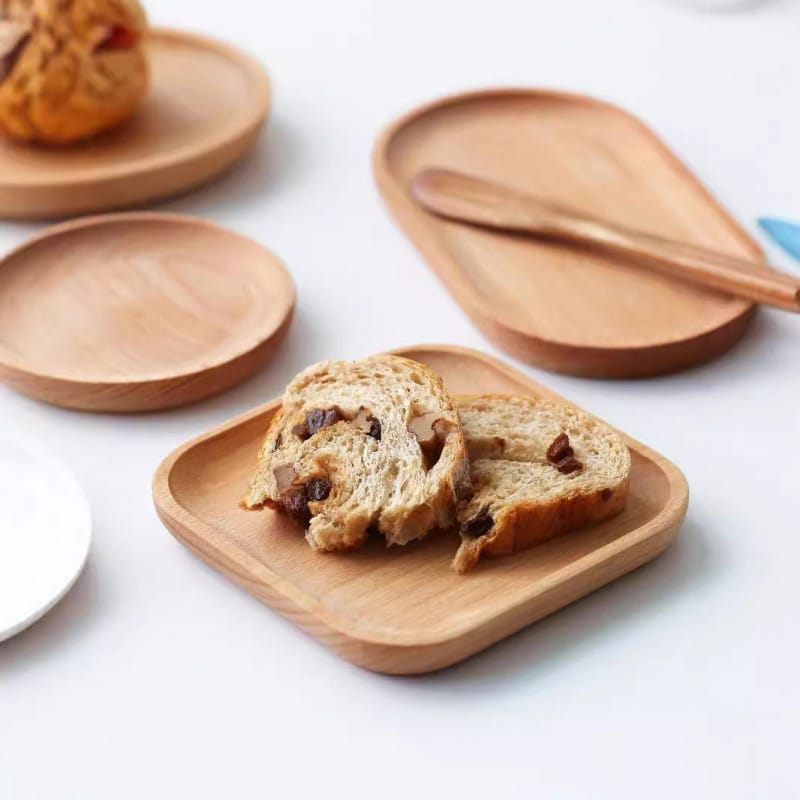 Beech wood oval cake tray and square wooden platters, perfect for serving bread, pastries, and more. Wholesale available.