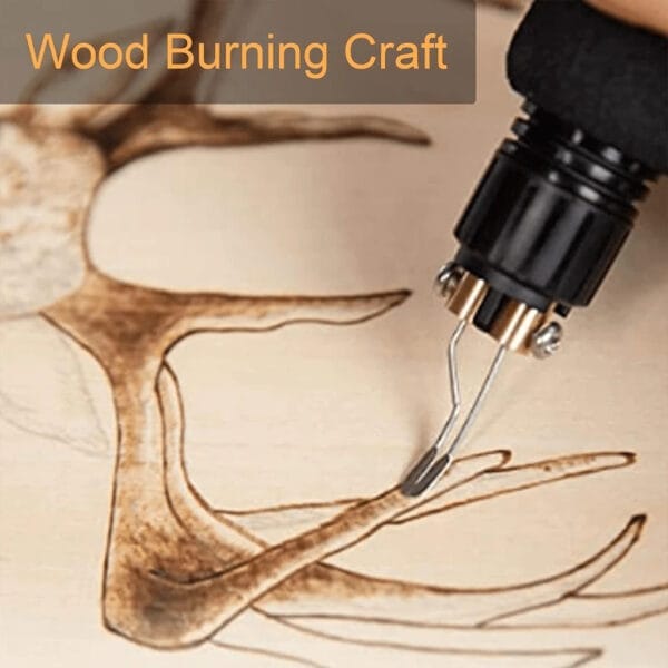 Wood burning craft in progress, creating a detailed antler design on a wooden plaque.