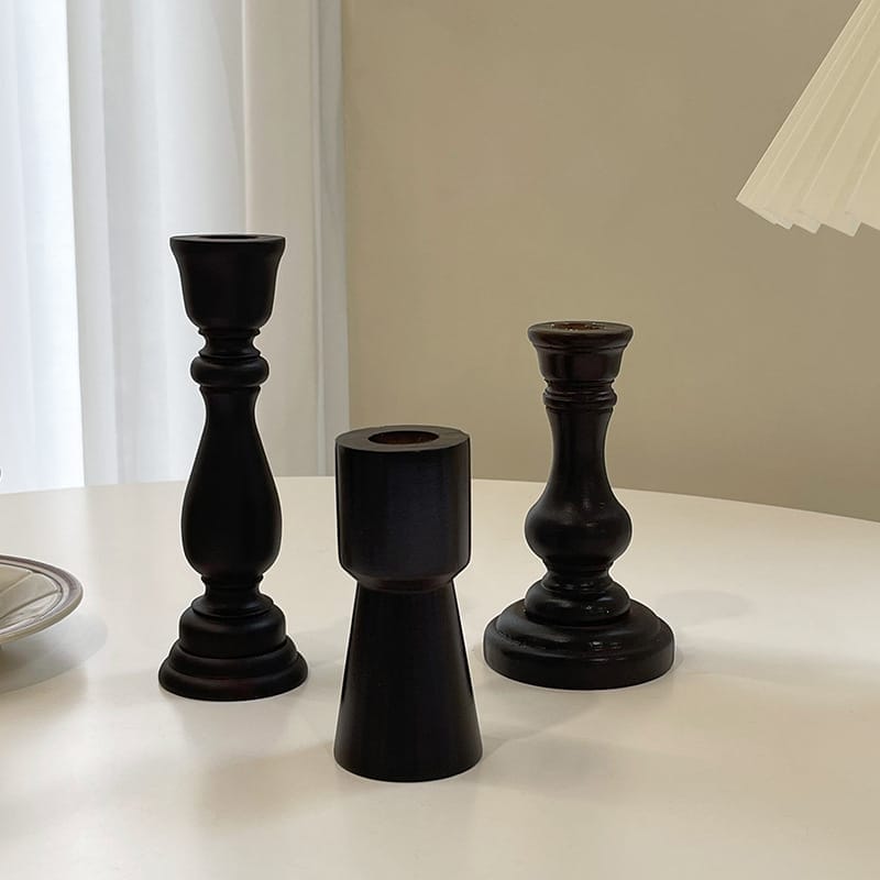 Three dark wood taper candle holders of varying heights. Wholesale candle holder supplier.
