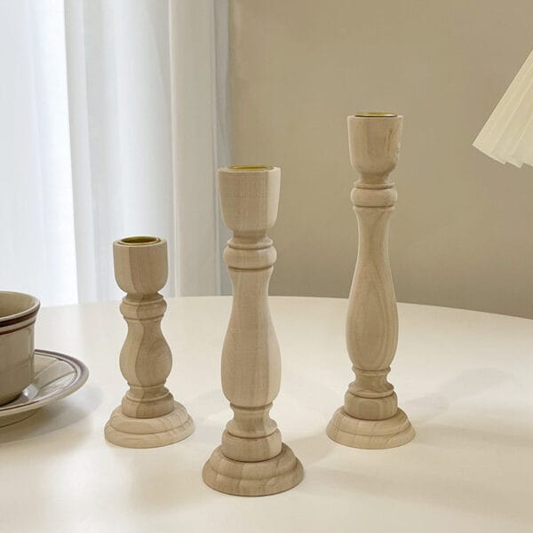 Three wooden taper candle holders of varying heights. Wholesale supplier of wood candle holders.