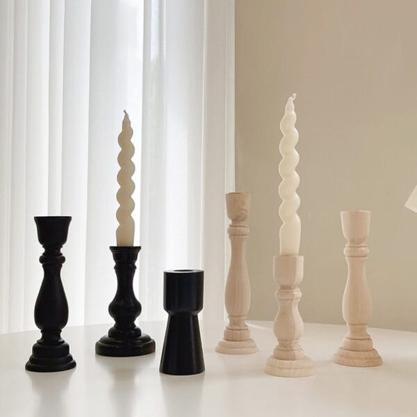 Wooden and black taper candle holders with candles. Wholesale candle holder supplier.