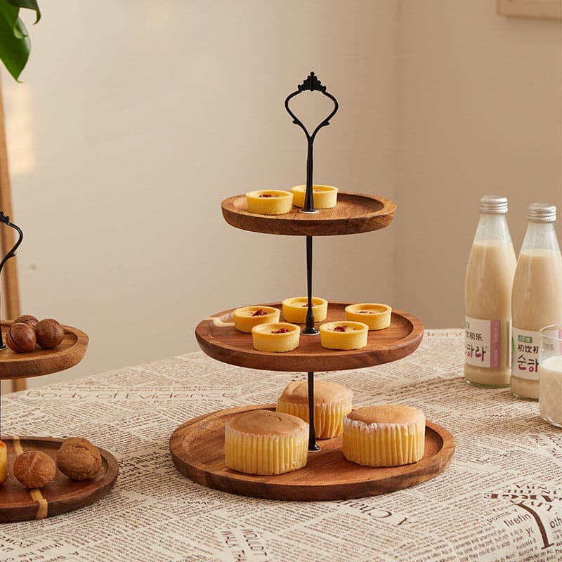 Two-tiered wooden serving tray with pastries and nuts. Ideal for wholesale.
