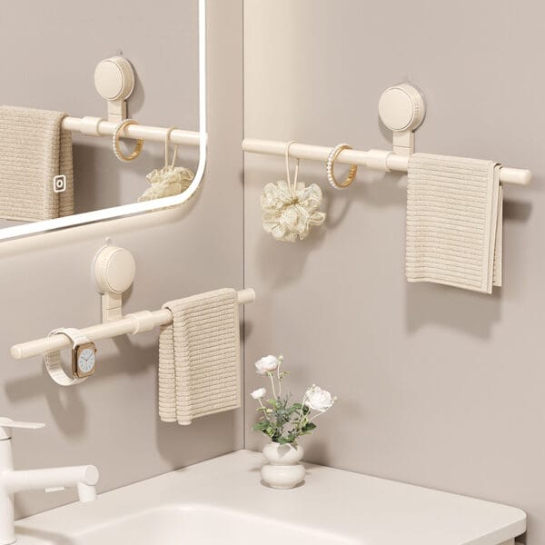 Space-saving corner bathroom towel rack: Three beige suction cup mounted towel bars, ideal for organizing towels, jewelry, and bath accessories.