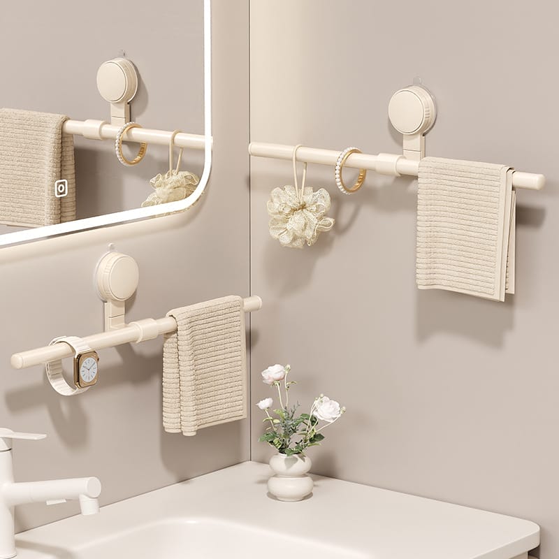 Space-saving corner bathroom towel rack: Three beige suction cup mounted towel bars, ideal for organizing towels, jewelry, and bath accessories.