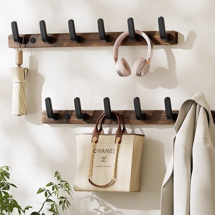 Walnut wood wall-mounted coat rack with black metal hooks; perfect entryway organizer for coats, bags, and more. Hallway storage solution.
