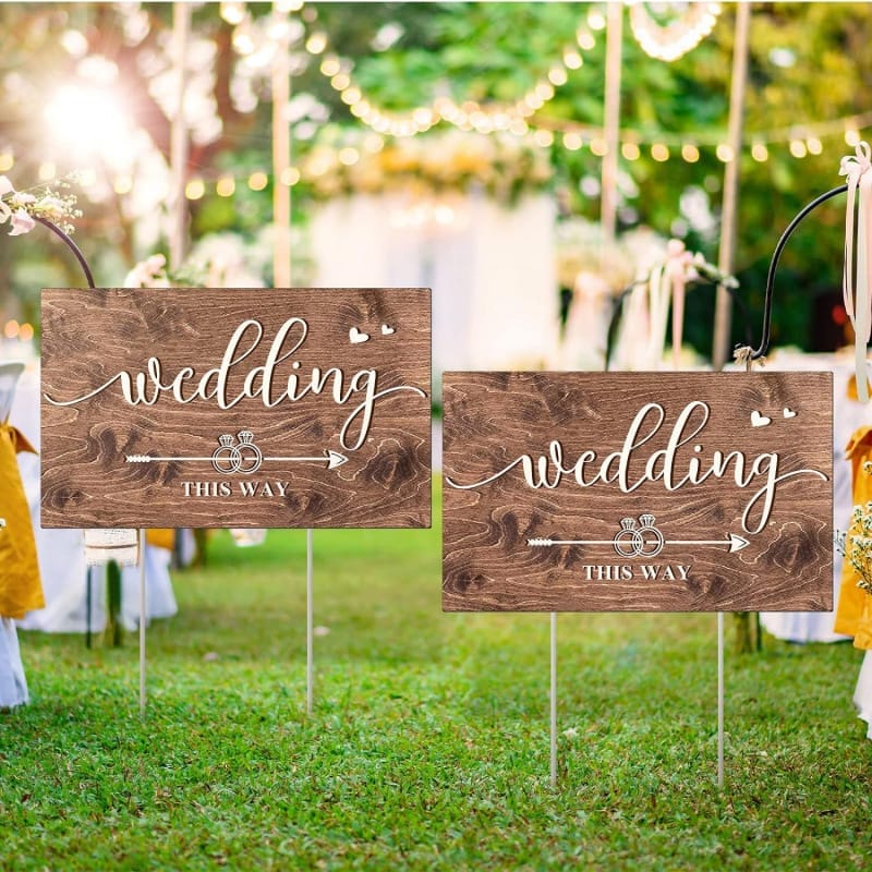 Rustic wooden wedding signs reading "Wedding This Way," perfect for directional signage at wedding venues.