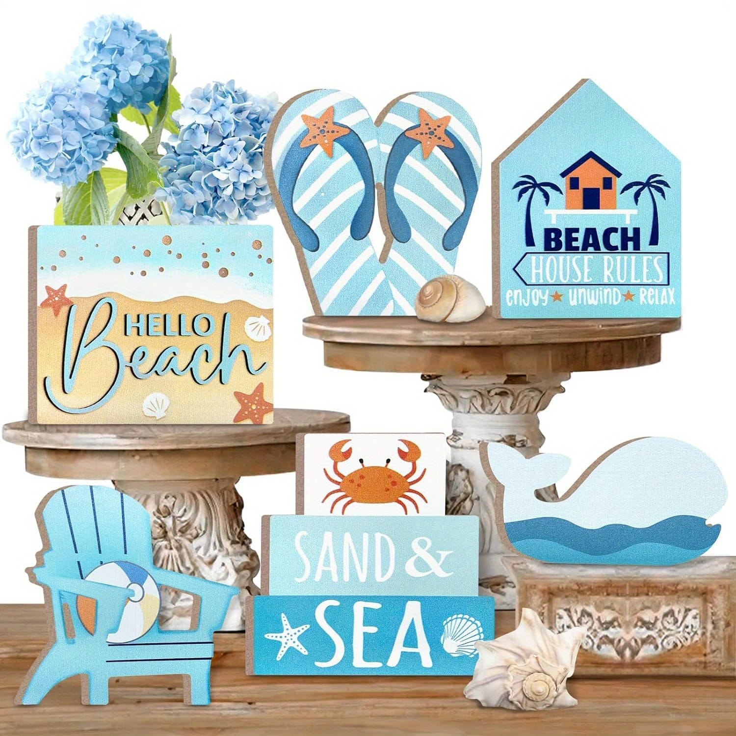 Wooden beach signs with summer themes, flip-flops, and seashells on a wooden table