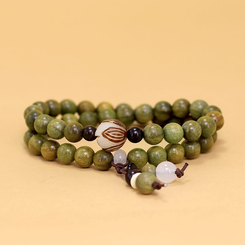 Double-strand green wooden bead bracelet with decorative accents. Wholesale decorative beaded bracelets available.