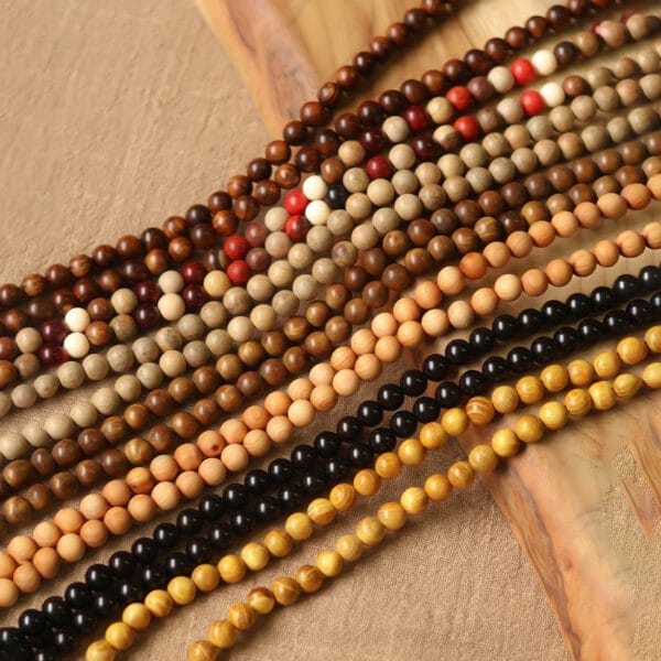 Assorted wooden bead necklaces in various colors and styles. Wholesale wooden beads available.